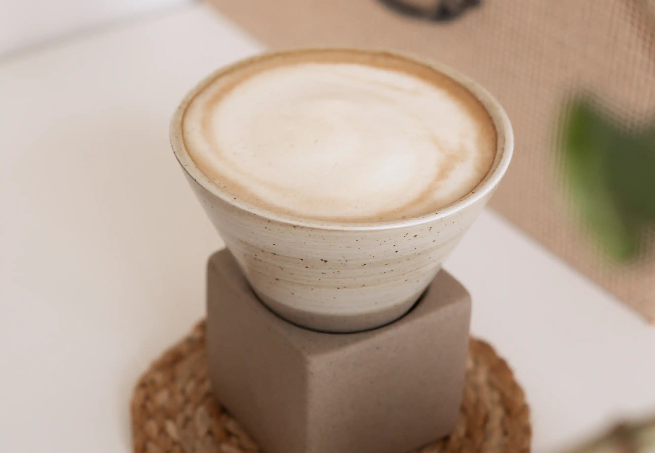 Aesthetic flatlay of instant coffee with milk, served in a ceramic coffee cup