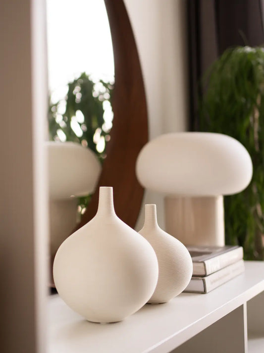 Cocoon Ceramic Vase set in matte white, featuring a minimalist round silhouette on a modern shelf.