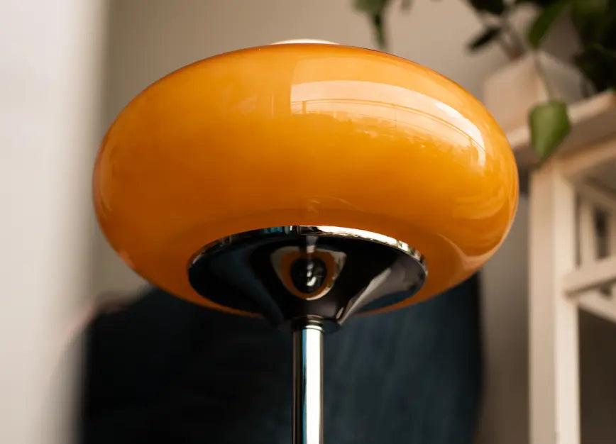 Close-up of an orange shade of Dawn Table Lamp with a blurred background