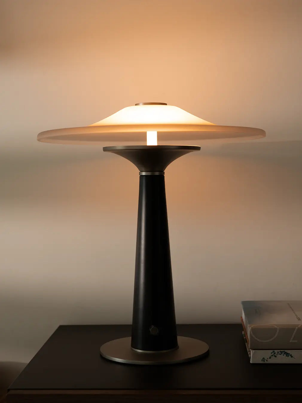 Modern Disc Glass Table Lamp on side table with soft ambient light and premium black-silver base