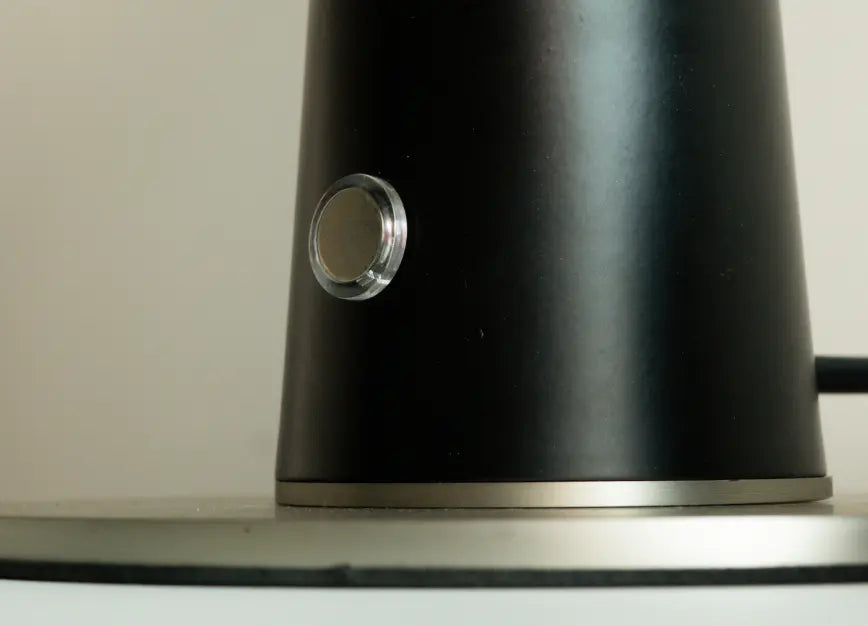 Touch sensor button on black metal base of modern Disc Glass Table Lamp