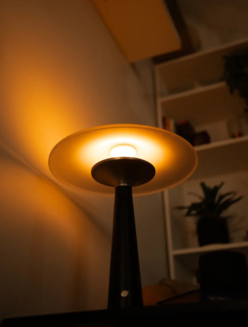 Upward angle of Disc Glass Table Lamp showing soft light diffusion through frosted shade