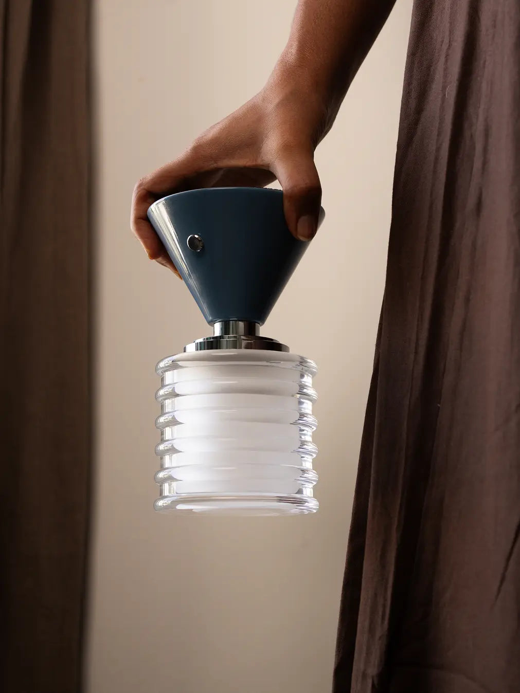 Dusk Table Lamp with ribbed glass shade, blue cone base, and rechargeable LED light