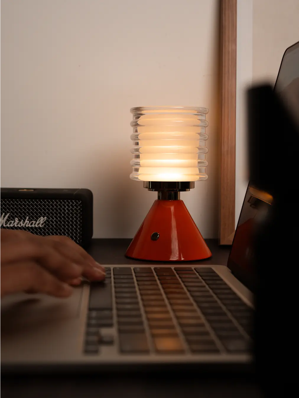 Dusk Table Lamp with orange cone base, ribbed glass shade, and warm LED glow
