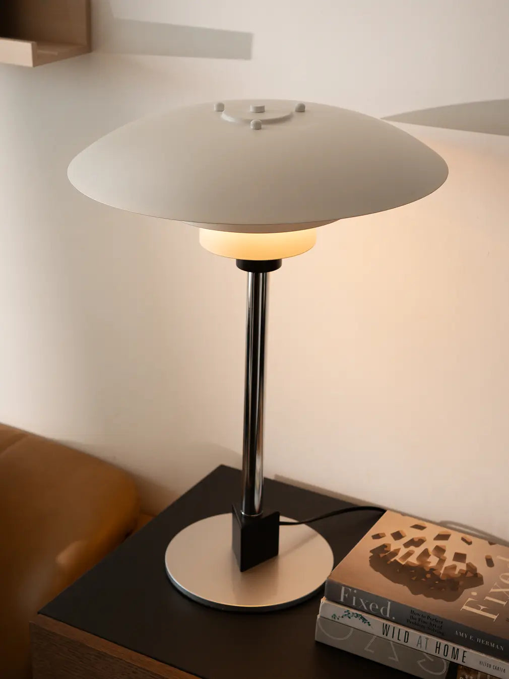 Echo Metal Table Lamp with matte white shade and silver base styled on bedside table