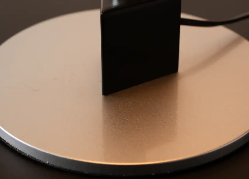 Close-up of Echo Lamp’s silver metal base with black accent and power cord detail