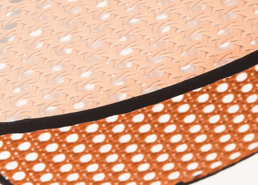Close-up of Hanai Floor Lamp’s handwoven rattan panels, highlighting intricate craftsmanship.