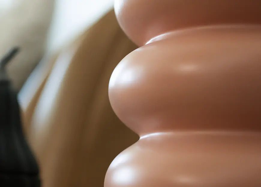 Close-up of the Orbit Ceramic Vase - Peach, highlighting its smooth, layered ceramic structure.
