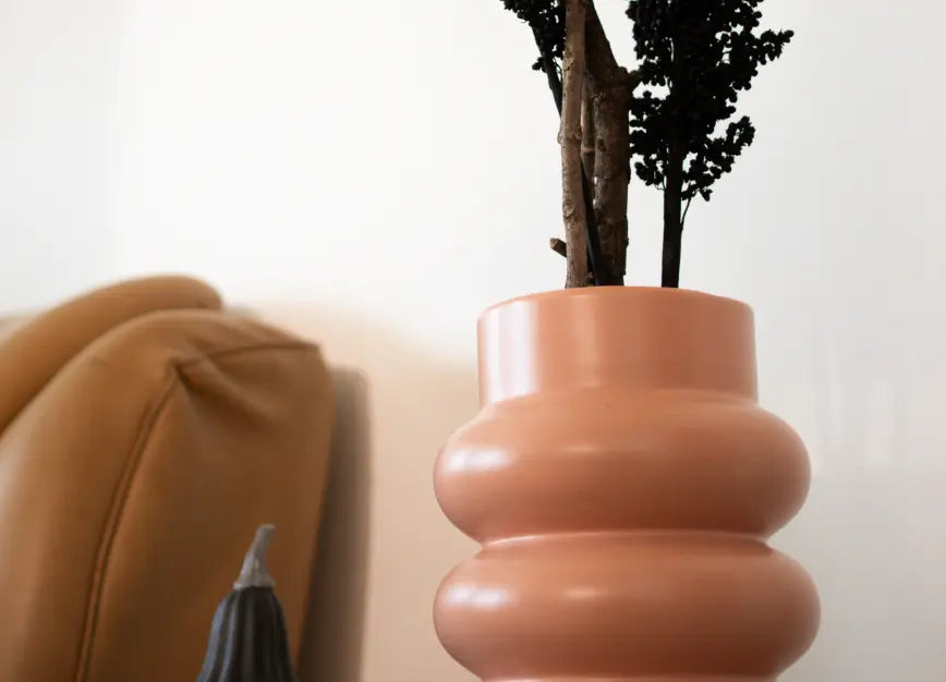 Orbit Ceramic Vase - peach, artistically arranged with dried flowers, highlighting its organic form.