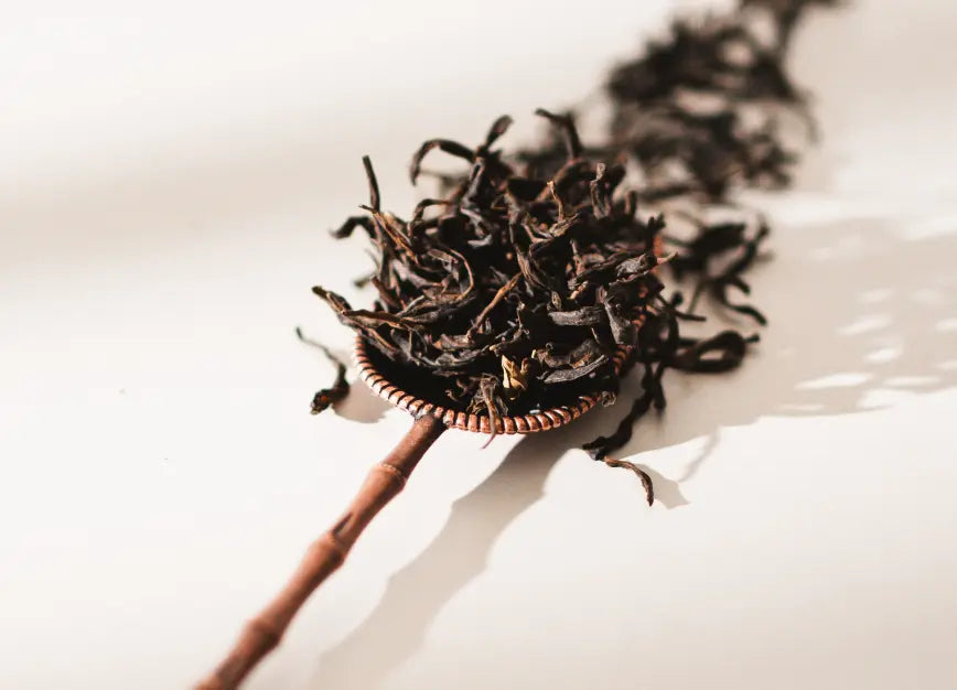 Vintage Spoon holding loose-leaf tea, displayed against a white background.