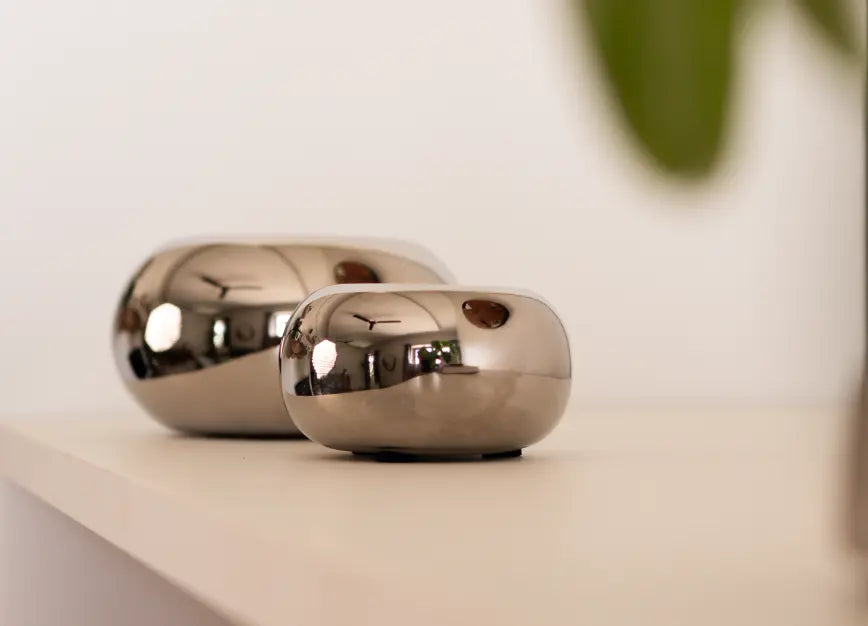 Set of two Donut Chrome Candle Holders in different sizes, displayed on a modern tabletop.