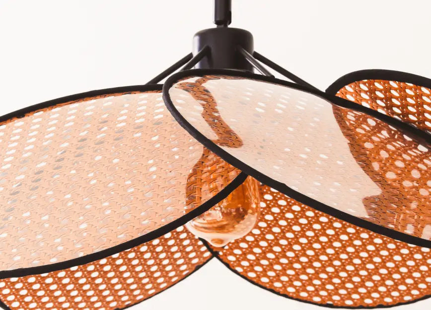 Hanai Floor Lamp with warm LED bulb featuring layered rattan panels and black metal structure.