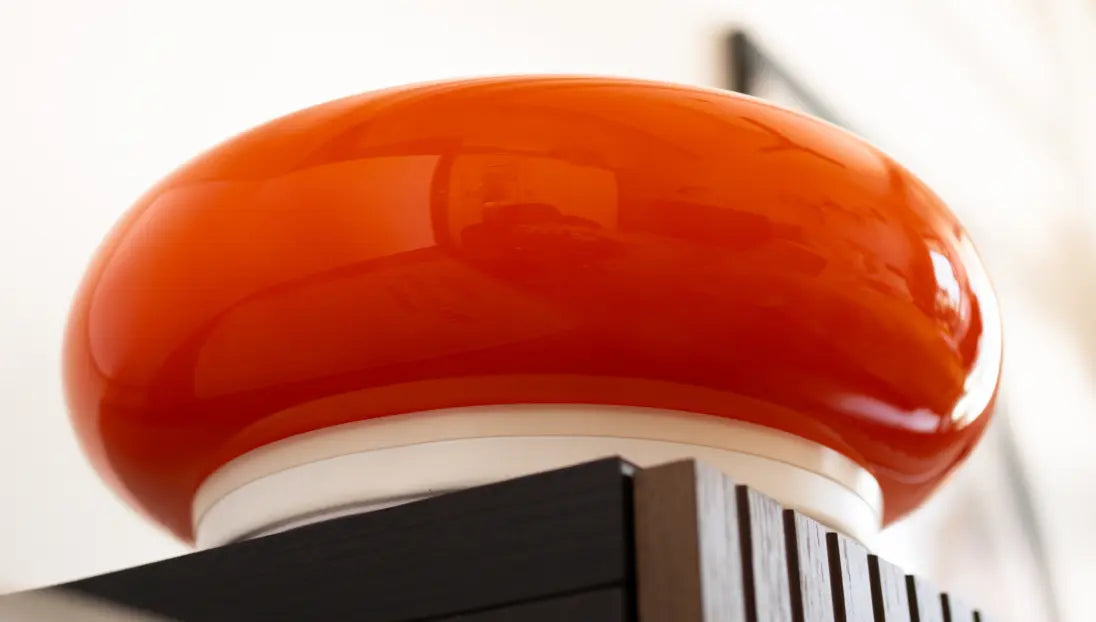 Close-up of Donut Glass Lamp's premium, vibrant orange hue glass texture and minimalist design.
