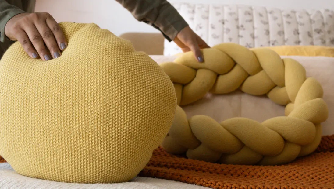 Disassembled Halo Nest Cushion in yellow, showing its inner cushion and separate braided border.