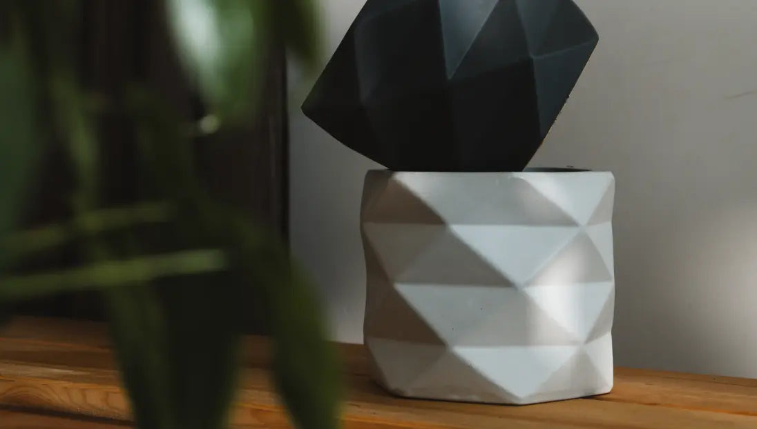 Stacked Diamond Ceramic Planters in black and white, displaying a modern, geometric aesthetic on a wooden surface.