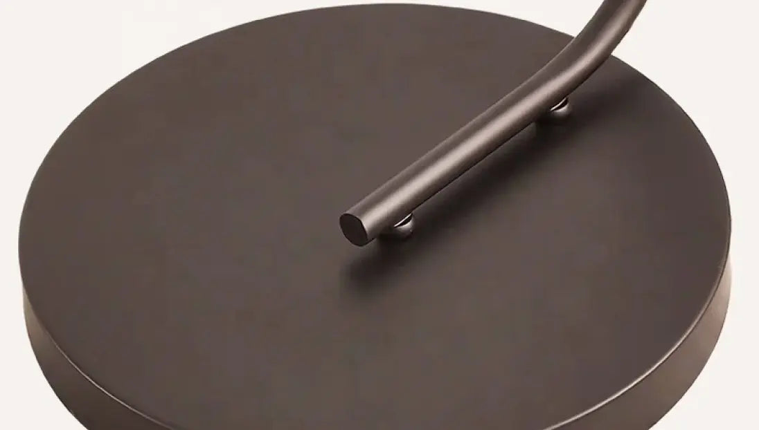 Detailed view of Hanai Floor Lamp’s sturdy black metal base, ensuring stability and durability.