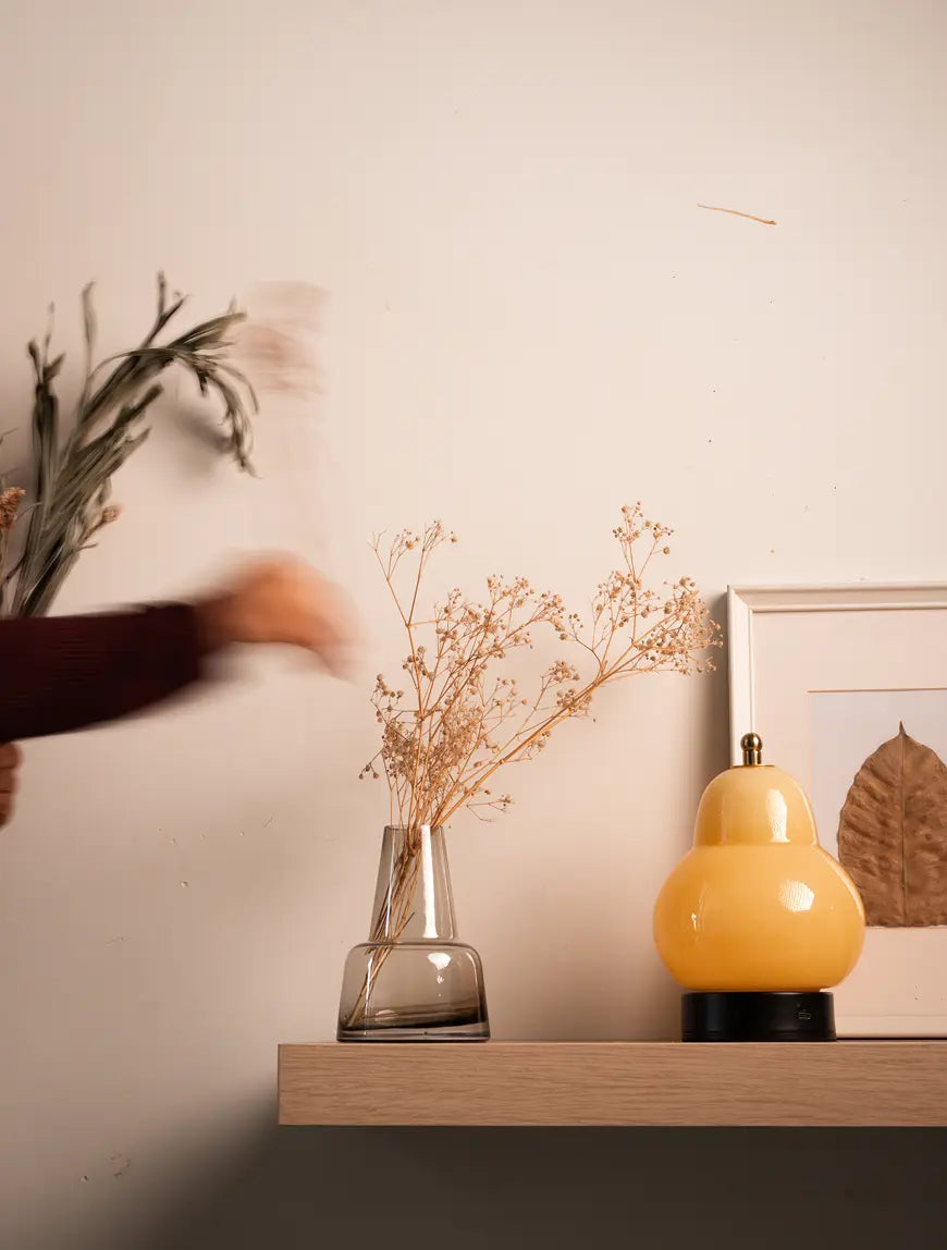 Elegant Pitcher glass vase - medium neck, styled on a wooden shelf with a glass lamp.