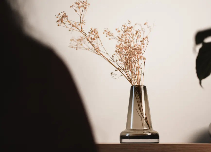 Pitcher Glass Vase - Long Neck with dried flower on a wooden shelf.