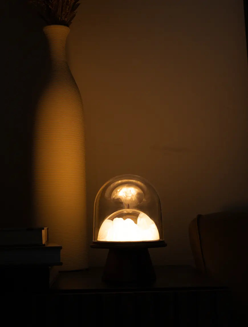 Lighted portable lamp with a glass cover in a dimly lit room
