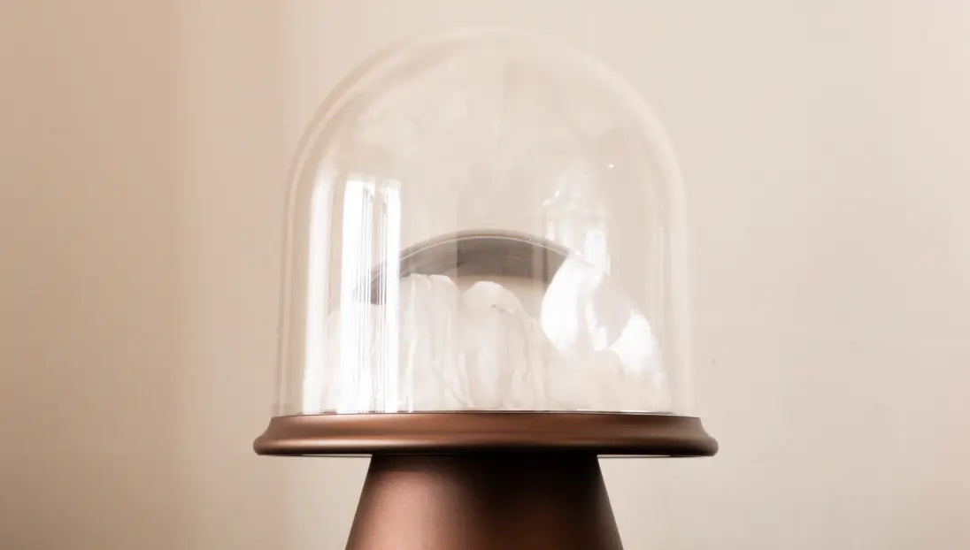 Close-up of a glass shade of Frozen Glass Table Lamp with wooden base on a beige background