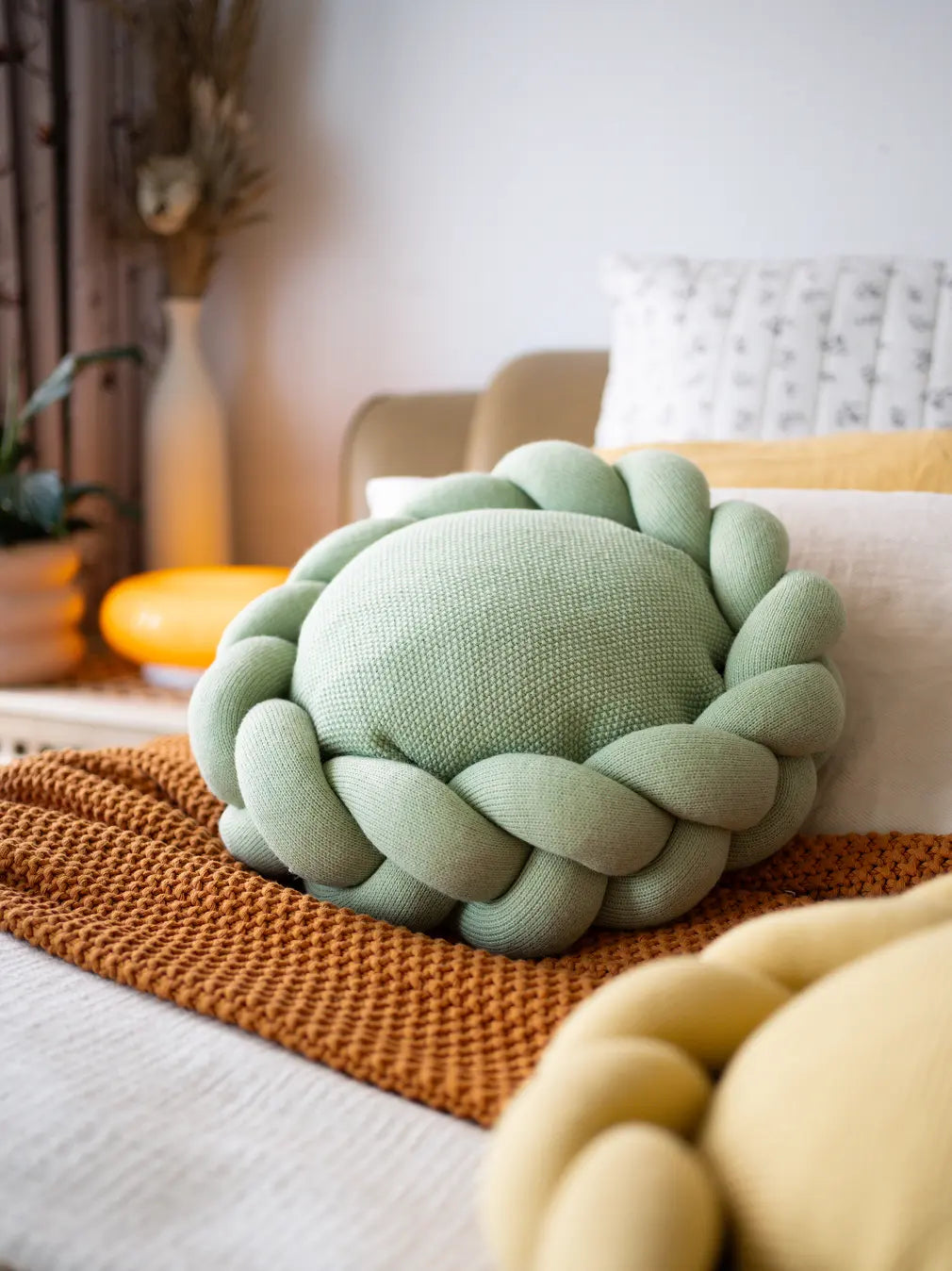 Gharko Halo Nest Cushion in green placed on cozy bedroom setup