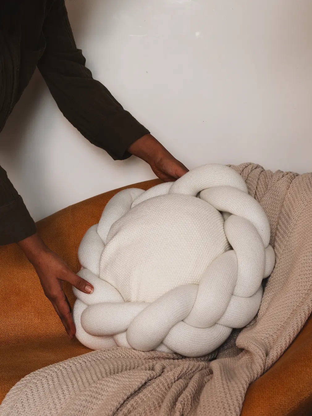 Gharko white Halo Nest Cushion styled on sofa with throw
