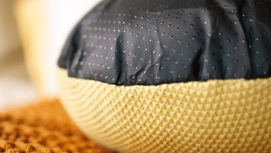 Non-slip dotted black bottom of Gharko yellow cushion for secure placement