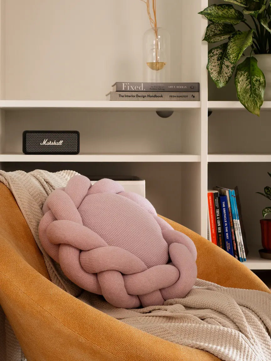Gharko pink decorative cushion styled on chair with throw