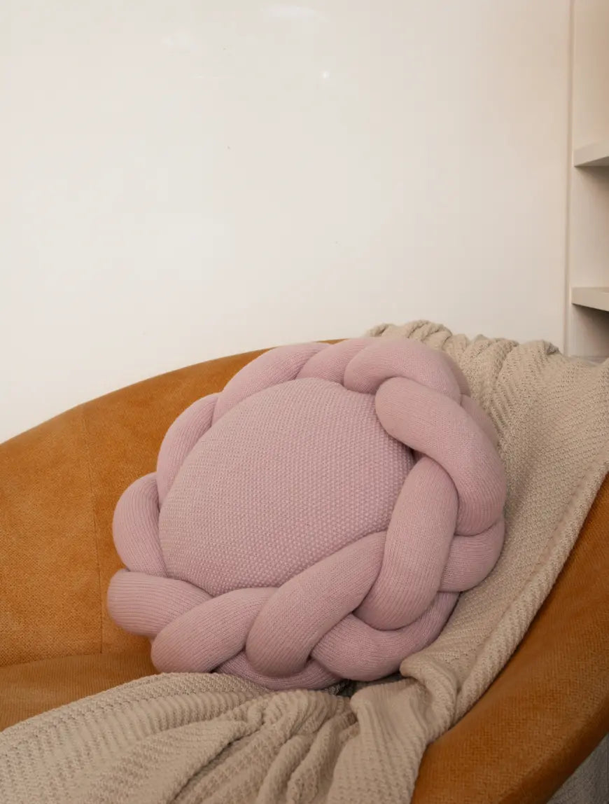 Pink Halo Nest Cushion by Gharko styled on beige knit throw chair