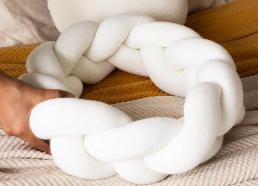 Braided knit ring of the white round cushion shown in hand