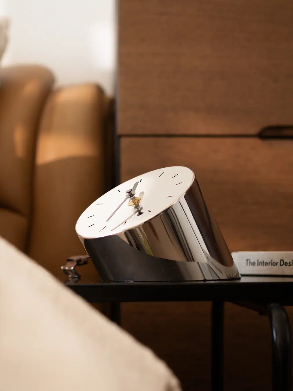 Horizon Metal Table Clock with slanted base on black side table in cozy bedroom