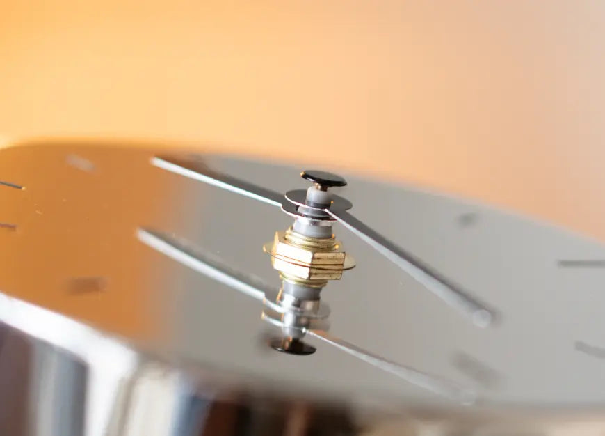 Close-up of Horizon Metal Table Clock showing brass detail and matte black clock hands