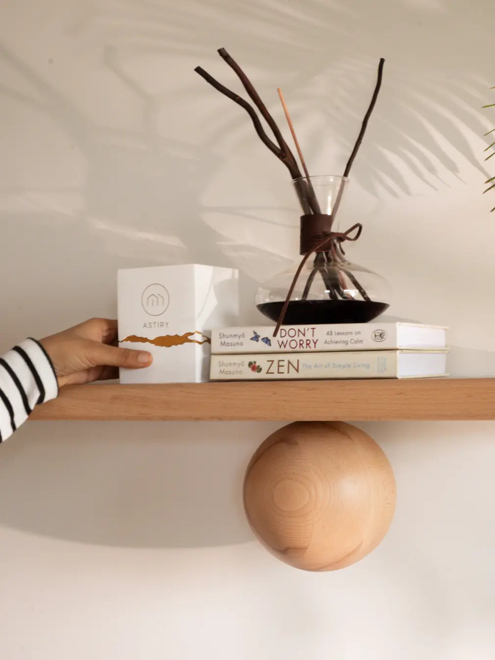Hand styling Gharko’s Orb Wooden Floating Wall Shelf with decor