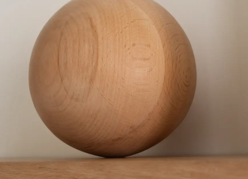 Detail view of sculpted wooden sphere on Orb Floating Wall Shelf