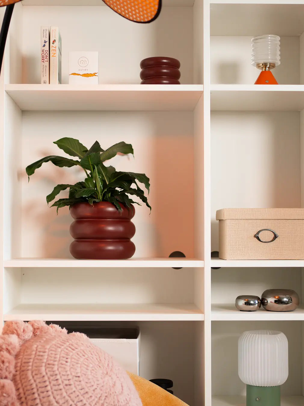 Orbit Ceramic Planter - Maroon styled on a bookshelf for a modern touch.