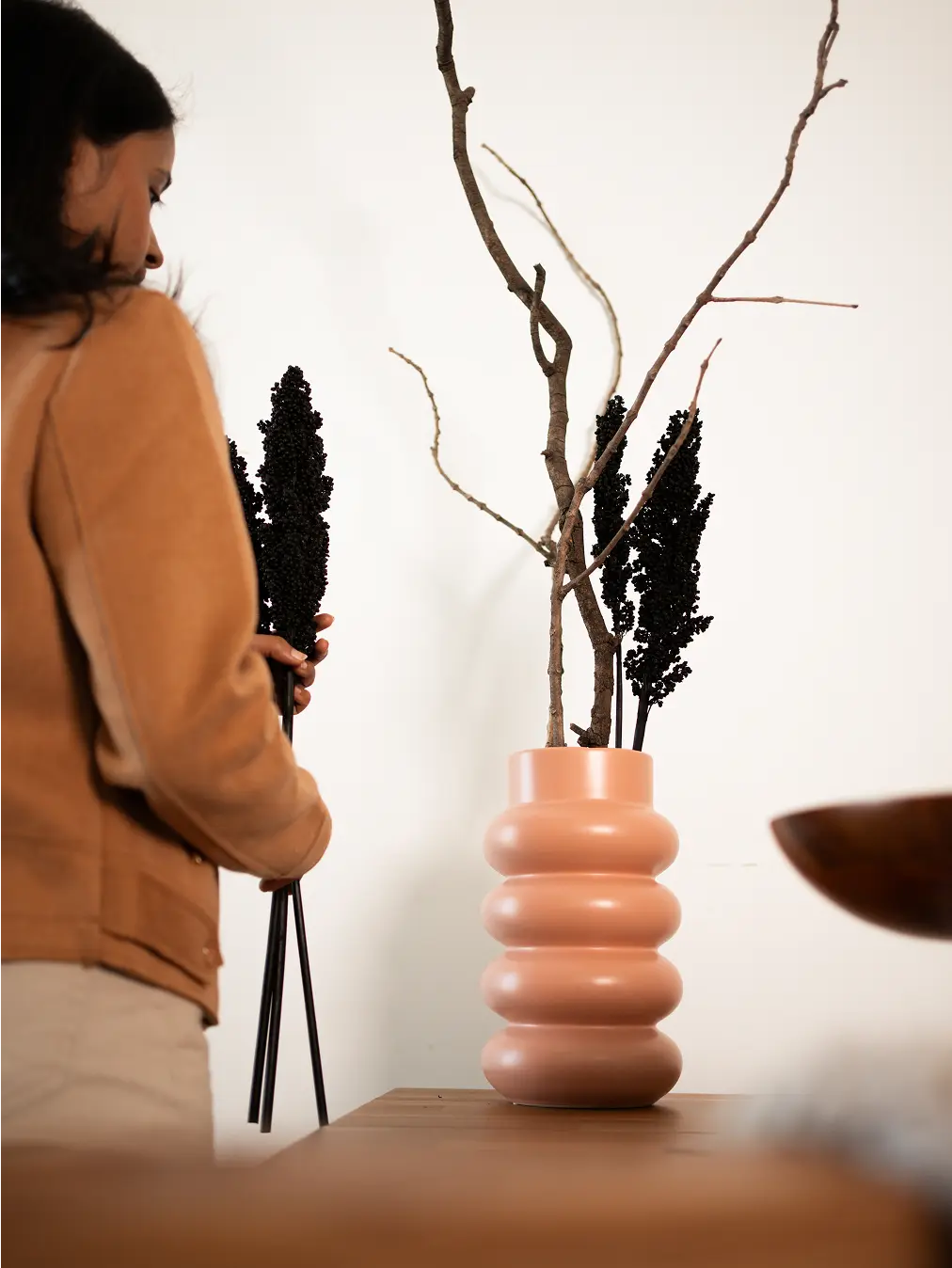 Orbit Ceramic Vase - Peach with stacked curves, styled with dried branches for an elegant, contemporary decor piece.