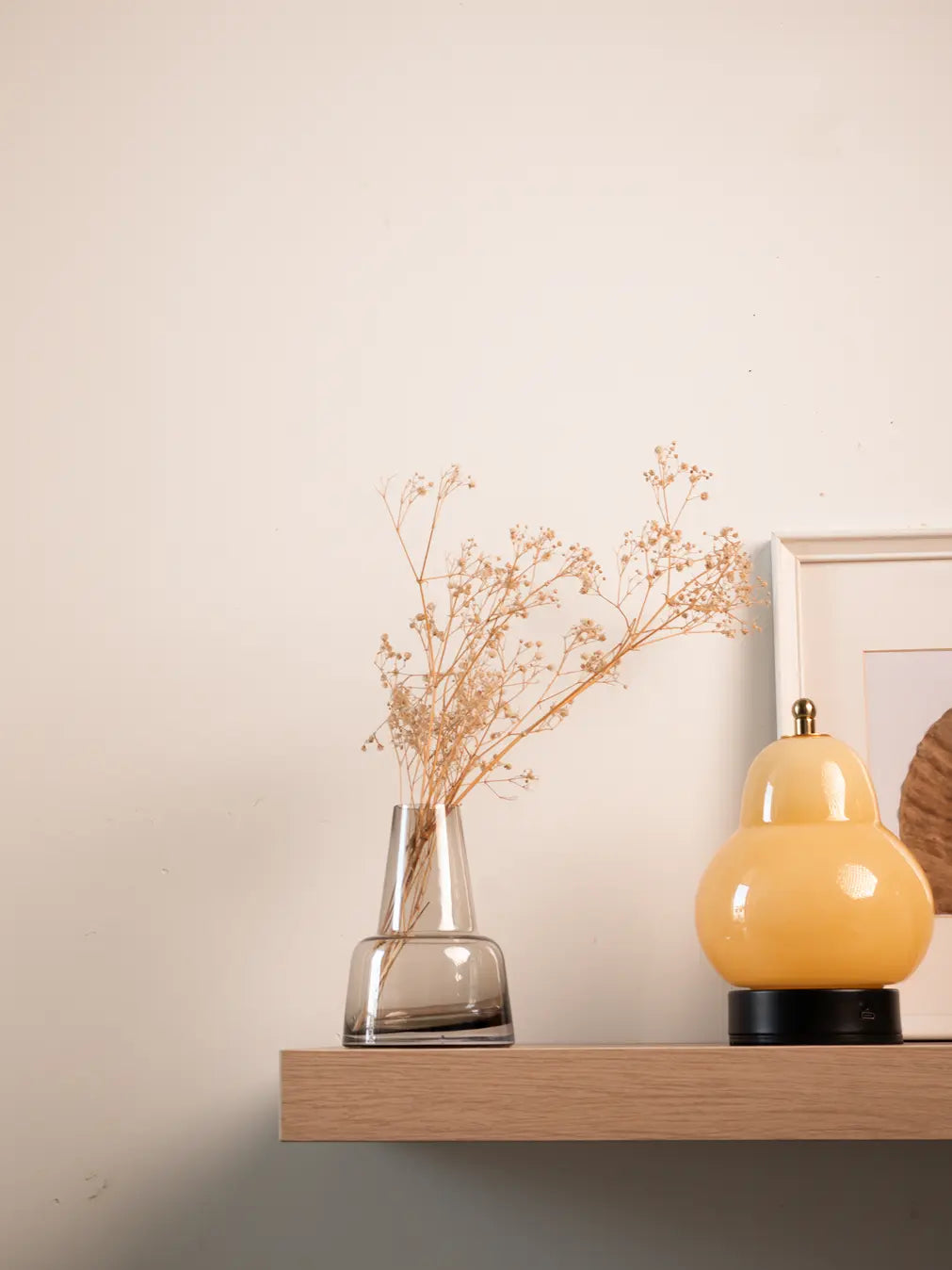 Pitcher Glass Vase - Medium Neck with dried baby's breath, styled on a wooden shelf with warm decor.