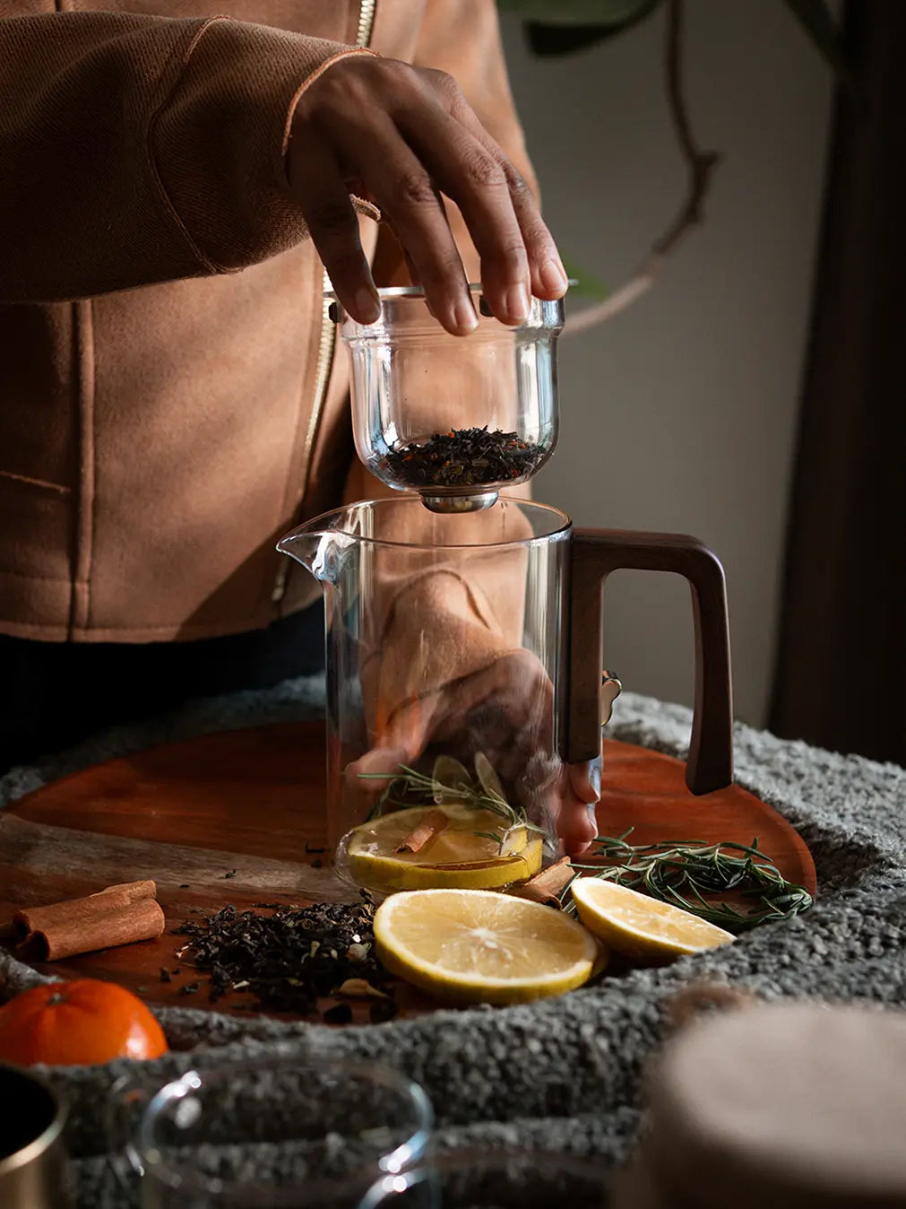 Adding loose tea leaves to the Pourfect Tea Infuser with a built-in glass strainer.