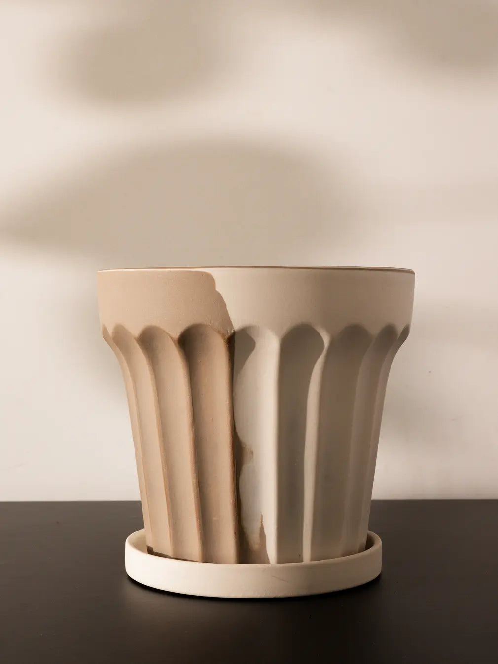 Close-up of an empty ceramic planter highlighting its sculptural fluted texture and handcrafted ceramic finish.