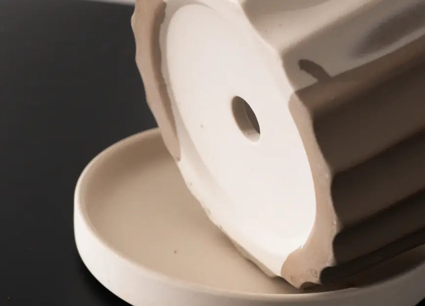 Bottom view of Raya Ceramic Planter with drainage hole and saucer detail.