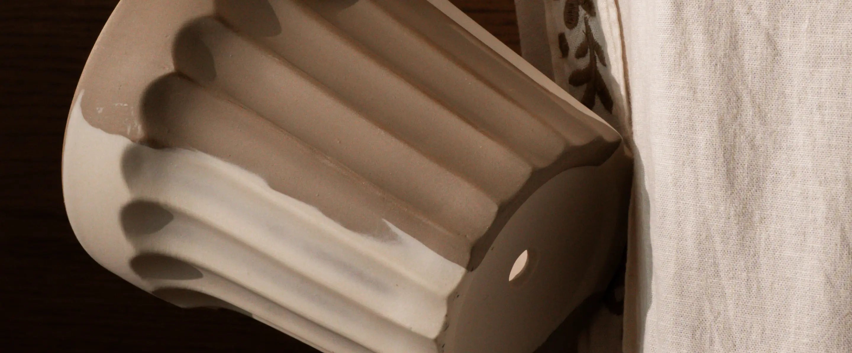 Close-up of fluted ceramic texture and drainage base of Raya Ceramic Planter.