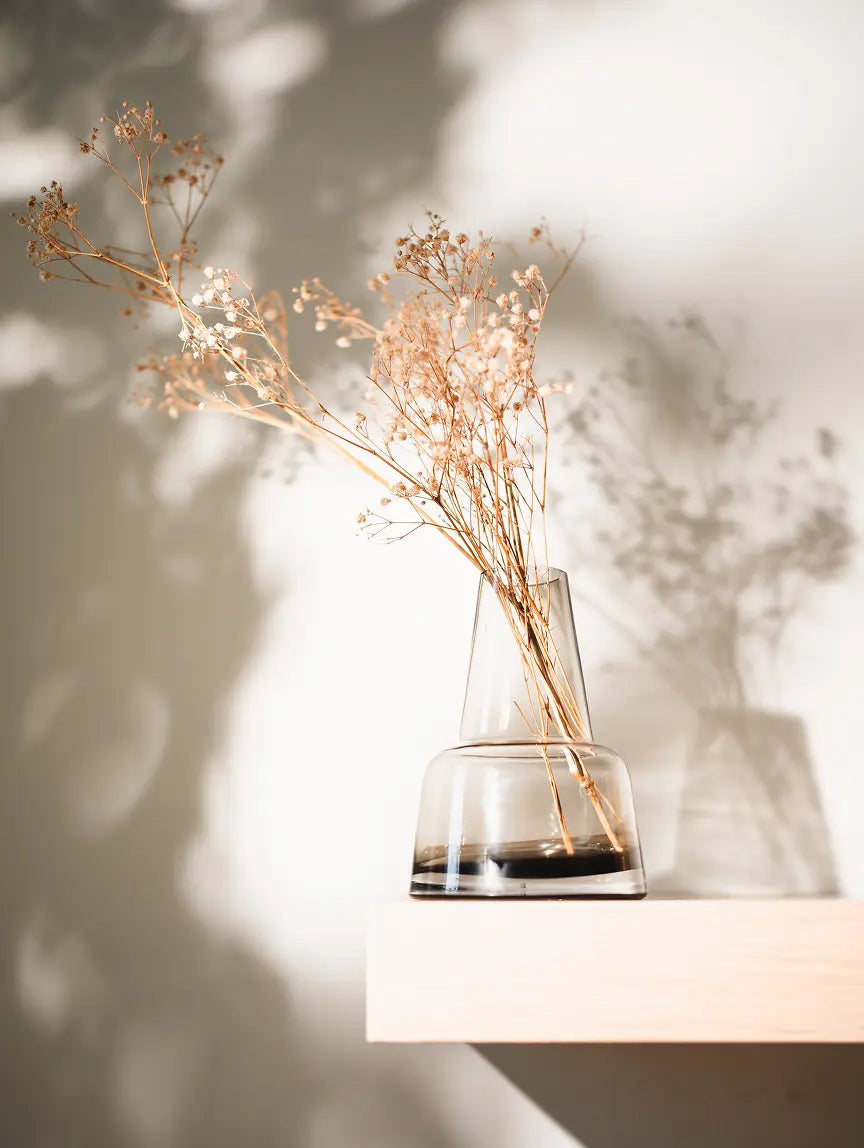Pitcher Glass Vase - Medium Neck with dried florals, placed on a wooden shelf with soft light.