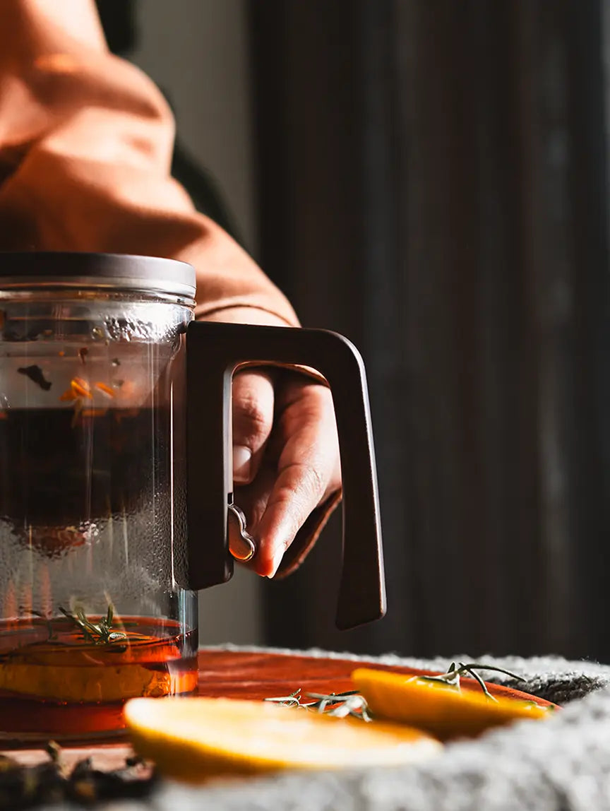 Close-up of the Pourfect Tea Infuser’s handle with stainless steel release mechanism.