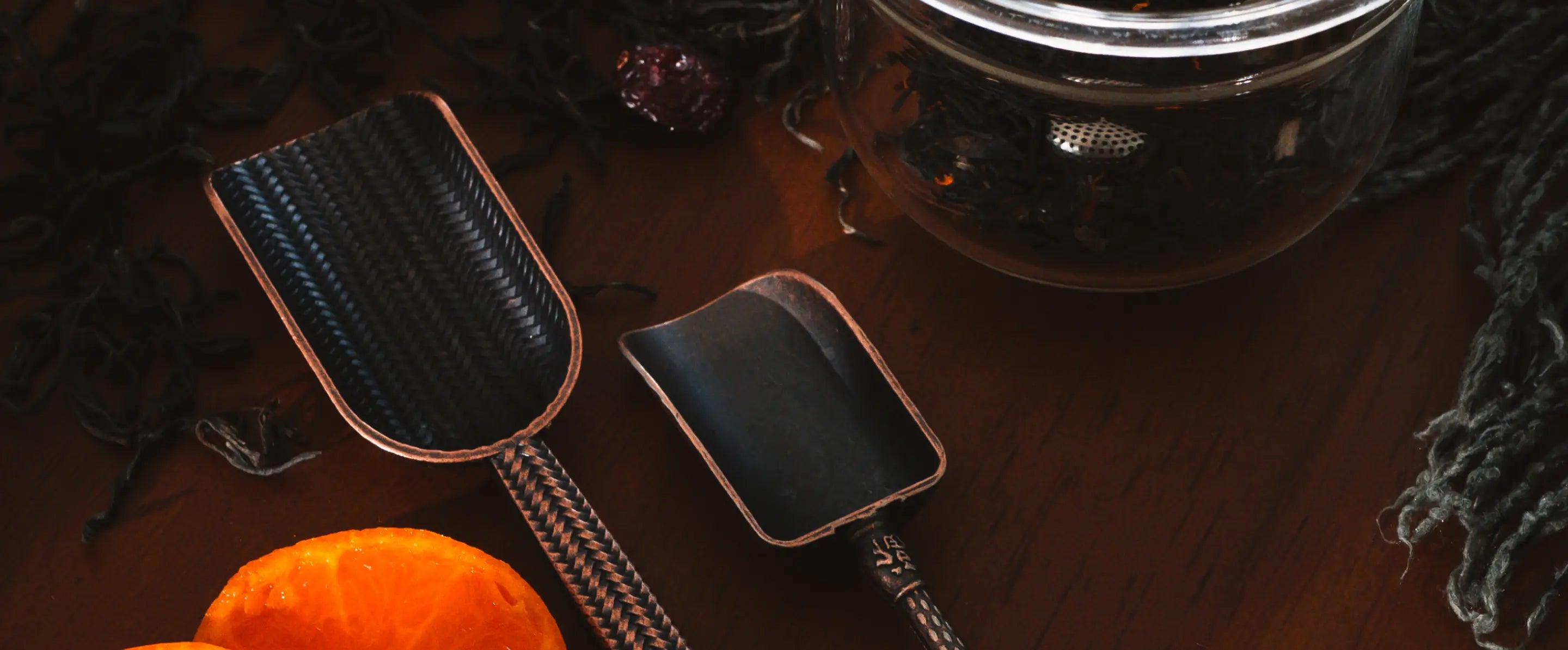 Vintage Spoon set with woven and engraved detailing, placed beside dried tea leaves.