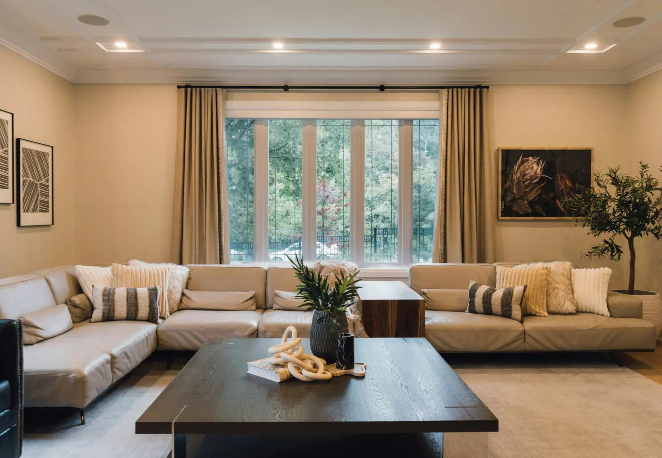 Neutral living room with sofa cushion covers, throws, plants and modern decor
