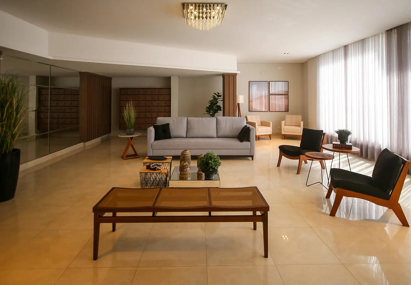 Warm minimalist living room with neutral sofa, wood furniture, indoor plants and soft natural light through sheer curtains.