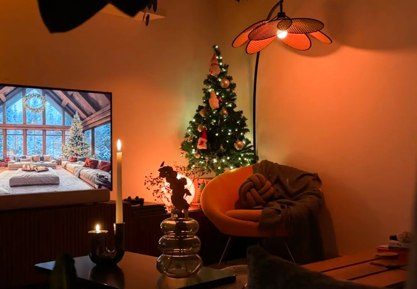 Minimalist Christmas living room with warm lighting, cozy seating, and softly lit tree