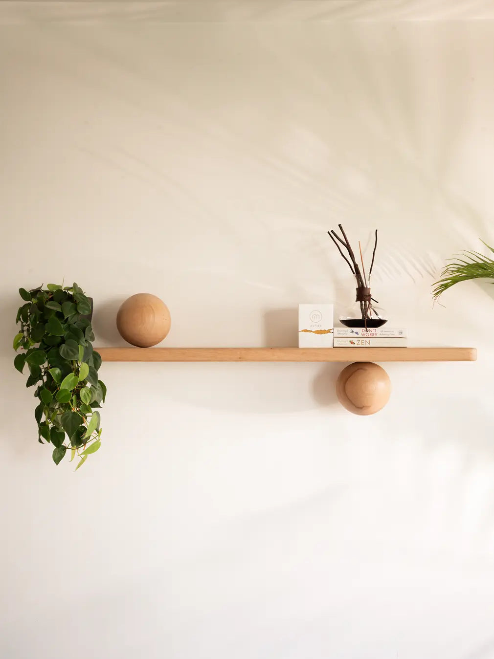 Japandi decor shelf with trailing plant, and minimalist home decor accessories