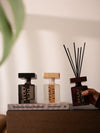 Premium reed diffusers with wooden caps in modern glass bottles for home fragrance.