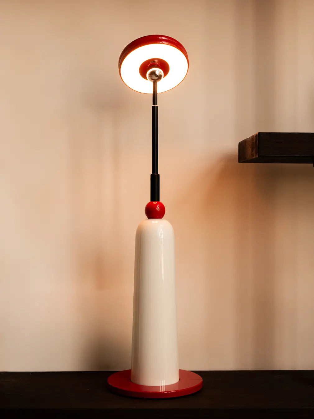 3-in-1 Frisbee Retractable Lamp styled as table lamp on console, warm ambient LED lighting.